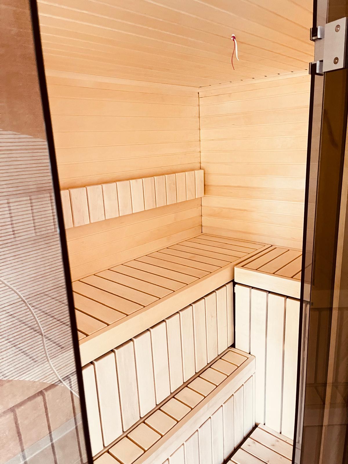 Bespoke Celsium indoor sauna with Aspen interior and smoked glass front at Design-Hotel Schutzhütte, Willingen, Germany
